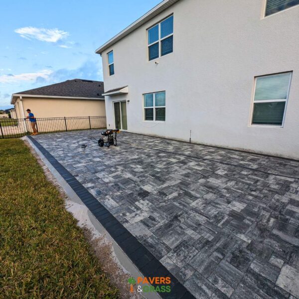 Backyard and sidewalks with white charcoal pavers