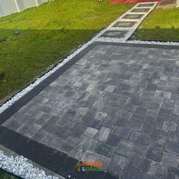 Design of a backyard prepared for a pergola’s installation Paversngrass