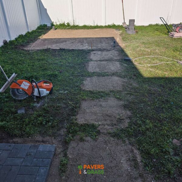 Design of a backyard prepared for a pergola’s installation Paversngrass
