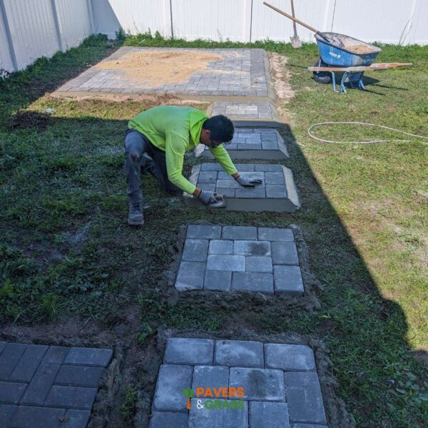 Design of a backyard prepared for a pergola’s installation Paversngrass