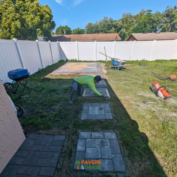 Design of a backyard prepared for a pergola’s installation Paversngrass