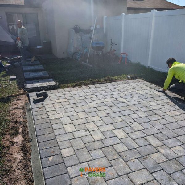 Design of a backyard prepared for a pergola’s installation Paversngrass