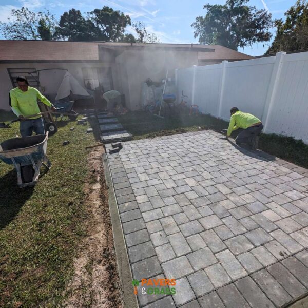 Design of a backyard prepared for a pergola’s installation Paversngrass