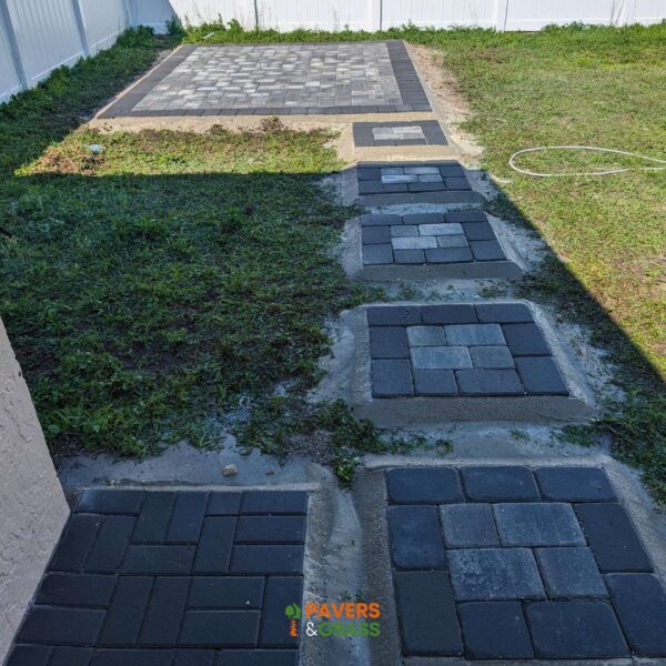 Design of a backyard prepared for a pergola’s installation Paversngrass