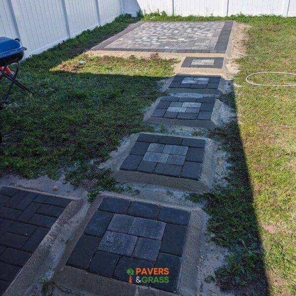 Design of a backyard prepared for a pergola’s installation Paversngrass