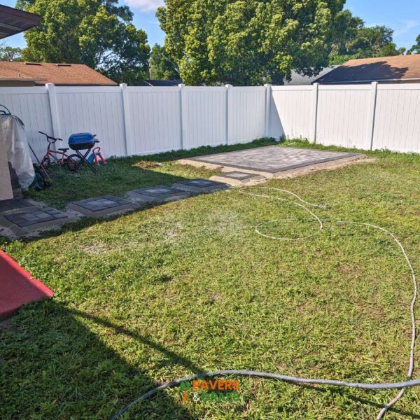 Design of a backyard prepared for a pergola’s installation Paversngrass